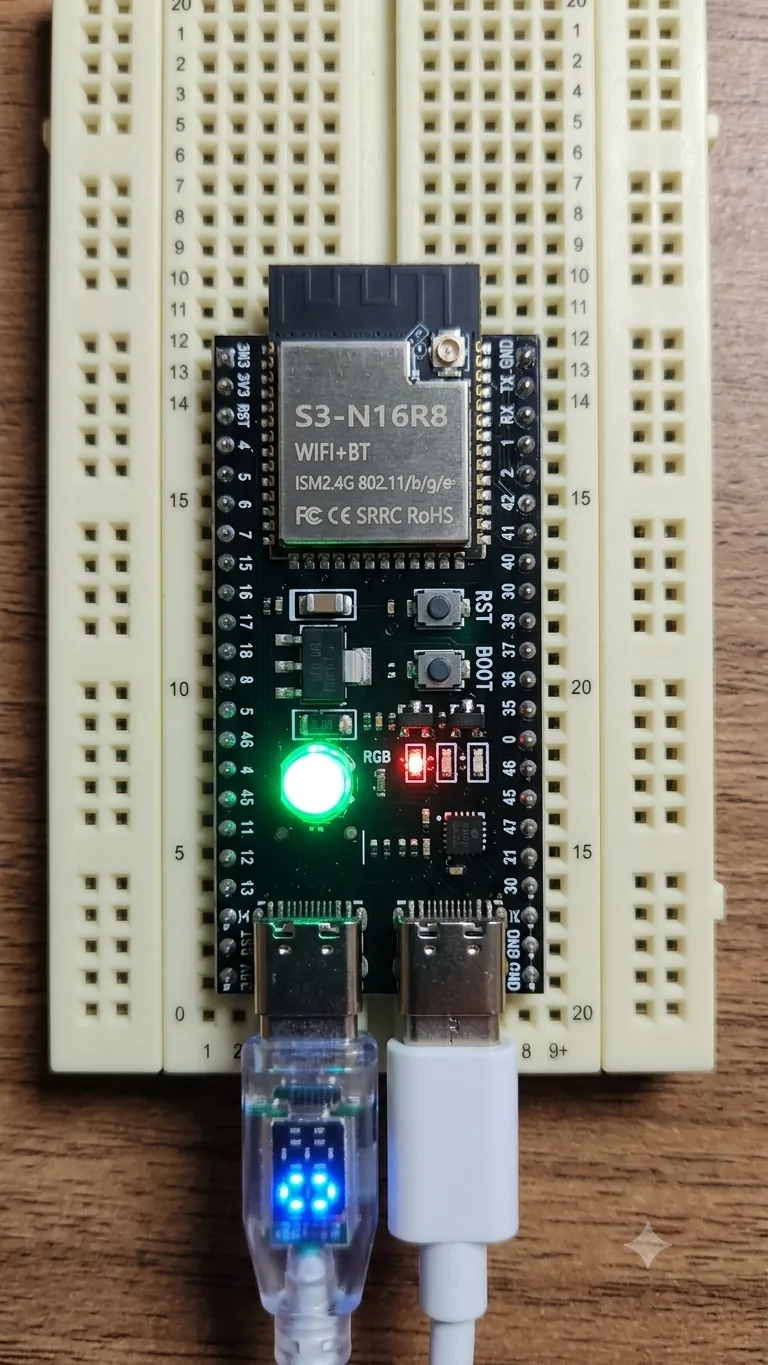 ESP32-S3-N16R8 board on a breadboard with both USB-C cables connected and the green LED lit — the firmware running during development.